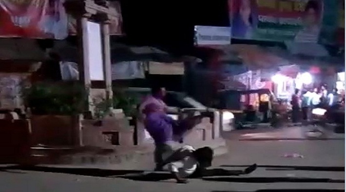 woman beating her drunken husband on crossroads in varanasi