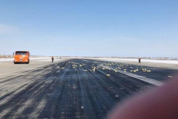 gold, platinum bars spill across russian runway plane