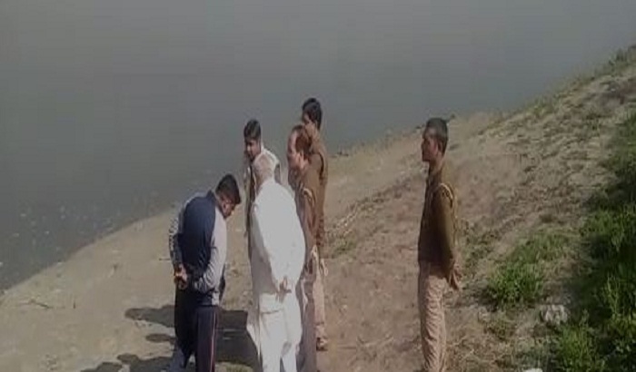 Farmers aboard the tractor immersed in river Yamuna